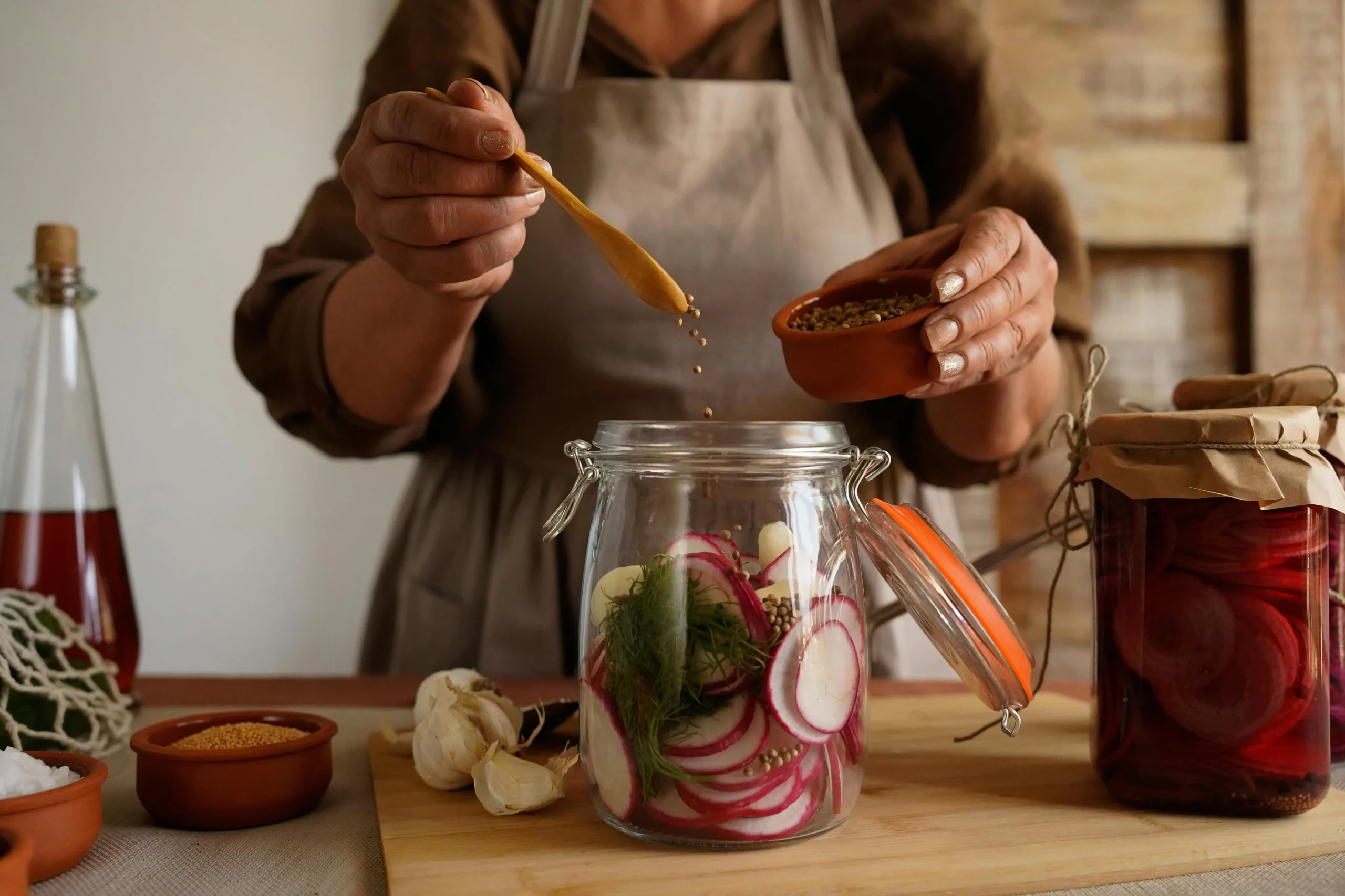 A close-up of marinated chicken pieces with vibrant spices and herbs, ready for cooking.