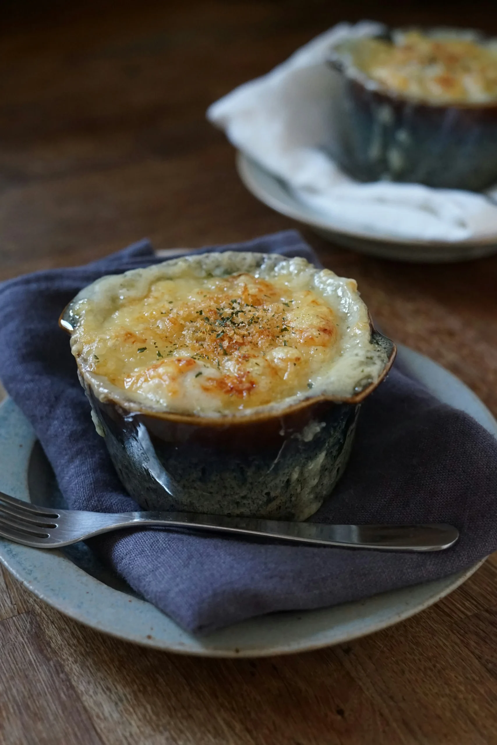 A crab brulee served in a rustic kitchen setting with fresh ingredients.